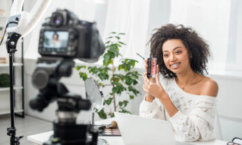 A beauty influencer filming a video for her lip gloss business