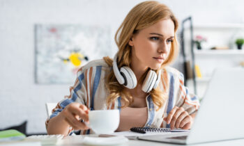 A female blogger reading a blog post online for six figure bloggers