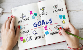 A woman prioritizing her goals in a planner