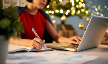 A woman working on her laptop with her work at anytime job