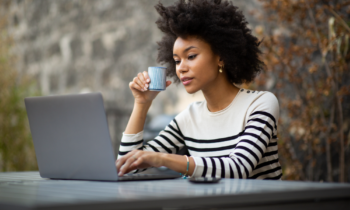 Woman taking surveys with User Interviews on her laptop